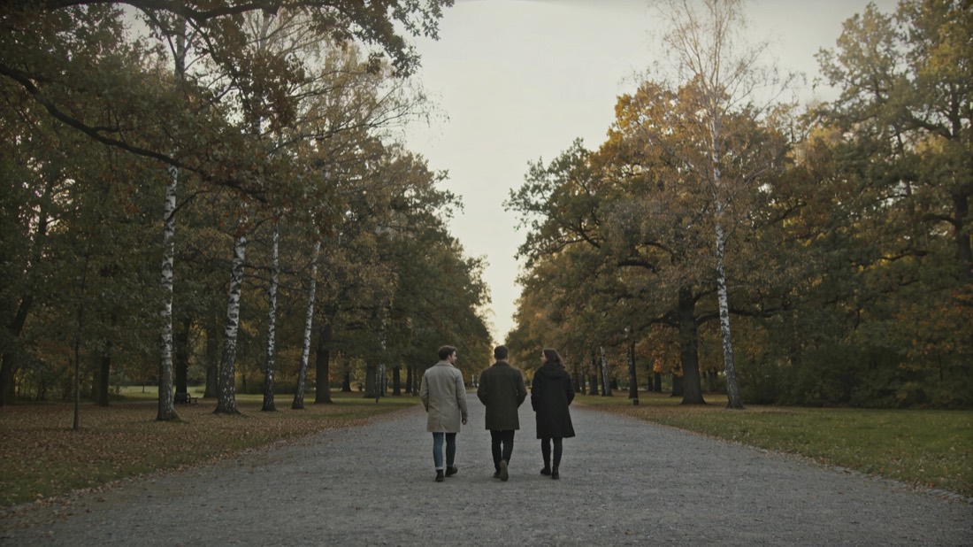 Three friends walking a park path